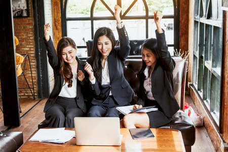 Successful business people celebrating with arms upの写真素材