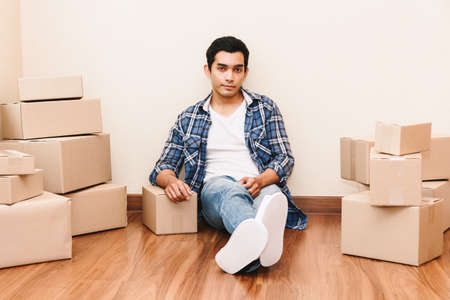 Young man with cardboard box at home - Business online and delivery conceptの写真素材