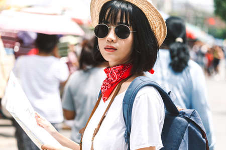 Woman tourist travel holding map and camera in the streetの写真素材