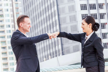 Businessman and partner giving fist bump handの写真素材