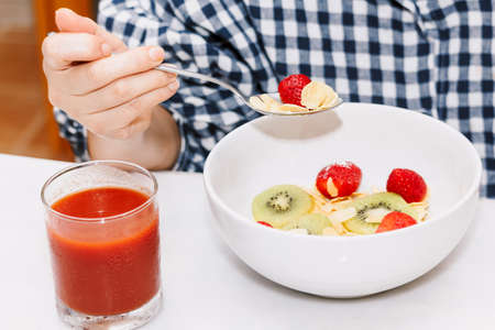 Woman dieting eating cereal and having breakfast in the kitchen.healthy lifestyle concept