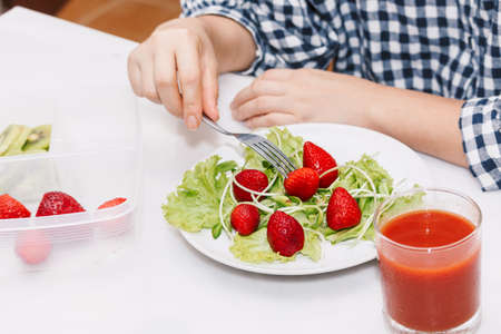 Woman eating fruit and vegetables in the kitchen.healthy lifestyle conceptの写真素材