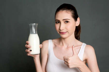 Woman holding glass of fresh milk.healthy lifestyle conceptの写真素材