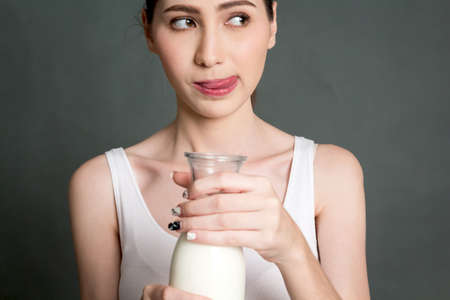 Woman holding glass of fresh milk.healthy lifestyle conceptの写真素材