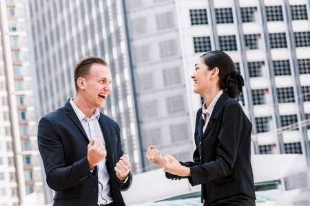 Successful business people celebrating with arms upの写真素材