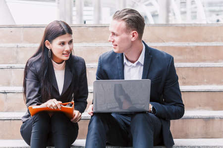 Image of two businessmen talking and working togetherの写真素材