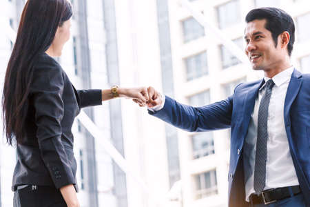 Businessman and partner giving fist bump handの写真素材