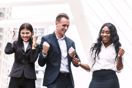 Successful business people celebrating with arms upの写真素材