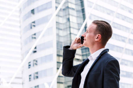 Handsome businessman using his smartphone