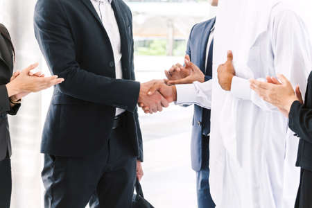 Successful businessmen handshake partner with arab businessman