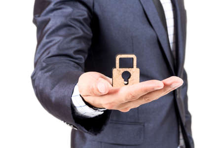 Businessman holding keys isolated on white backgroundの写真素材