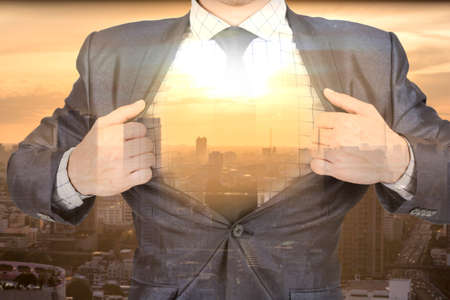 Businessman super hero with modern city.Double exposure photoの写真素材
