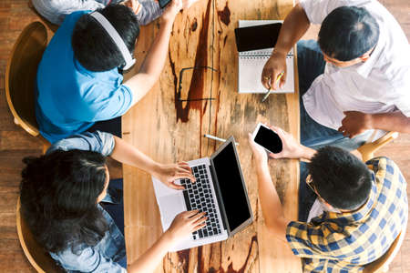 Group of teen high school students using a laptop and doing their homework