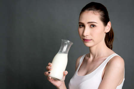 Woman holding glass of fresh milk.healthy lifestyle conceptの写真素材