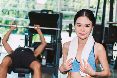 Young woman with towel in the gymの写真素材