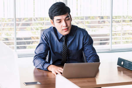 Businessman working with laptop computer at the officeの写真素材