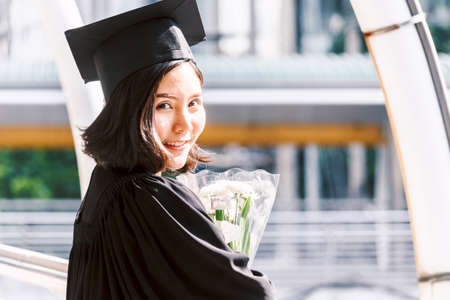 Happy woman students celebrating successful graduationの写真素材
