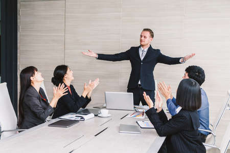 Successful business people clapping hands in the meetingの写真素材