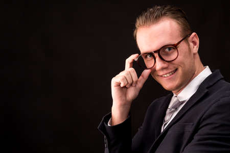 Portrait of handsome businessman on dark background