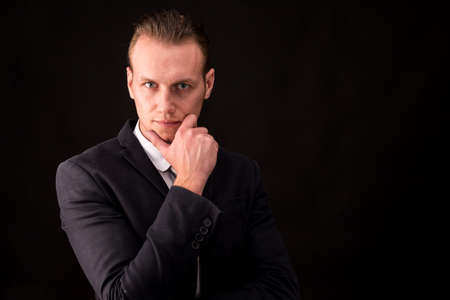 Portrait of handsome businessman on dark backgroundの写真素材