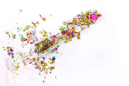 Colorful celebration with champagne glasses and colorful paper on white background.flat lay, top...