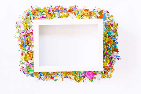 White photo frame with colorful paper on white background.flat lay, top viewの写真素材