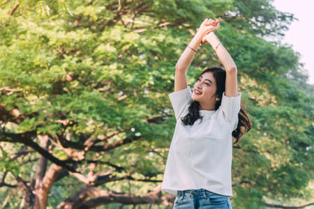 Woman standing stretch her arms relax and enjoy with nature fresh air