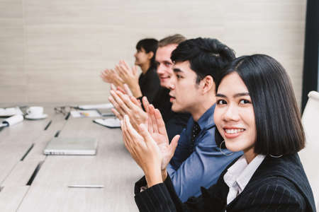 Successful business people clapping hands in the meetingの写真素材