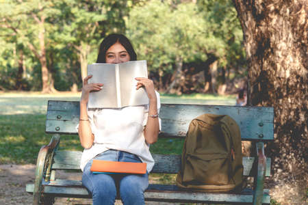 Students young woman relax and reading a book in parkの写真素材