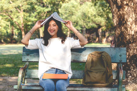 Students young woman relax and reading a book in parkの写真素材