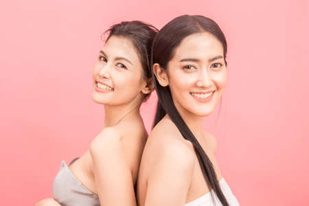 Portrait of two beautiful women beauty health care.beauty and spa.perfect fresh skin on pink backgroundの写真素材