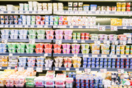Defocused blur of yogurt on shelves in a supermarketの写真素材