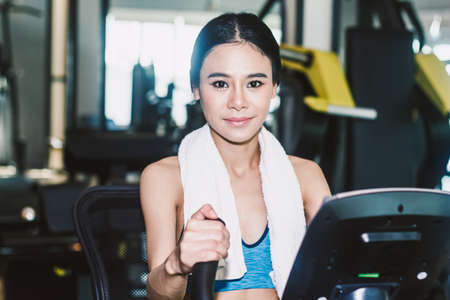 Fitness woman execute exercise with exercise-machine at the gym
