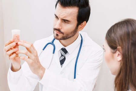 Doctor holding pill with patient  in hospital.healthcare and medicine