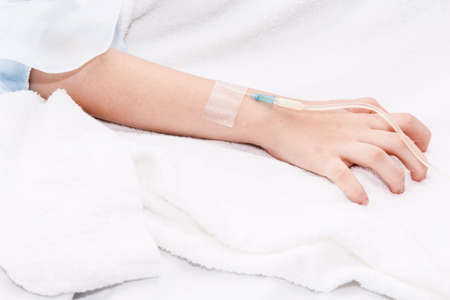 Little girl hand with IV saline intravenous in hospital