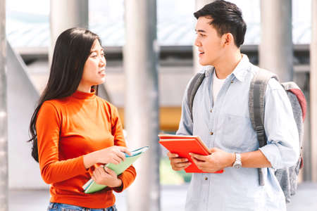 Group of students holding notebooks outdoors at university.Education concept