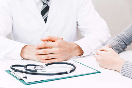 Doctor and woman patient consulting on doctors table in hospital.healthcare and medicine