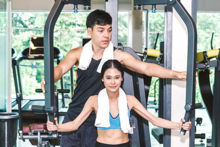 Handsome trainer and fitness woman at the gym.fitness and lifestyle concept