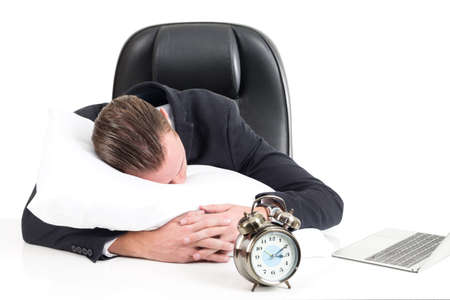 Young business man hugging and sleeping on pillow  isolated on white background