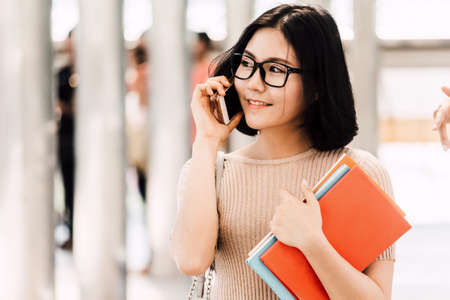 Young woman teenager students  with booksの写真素材