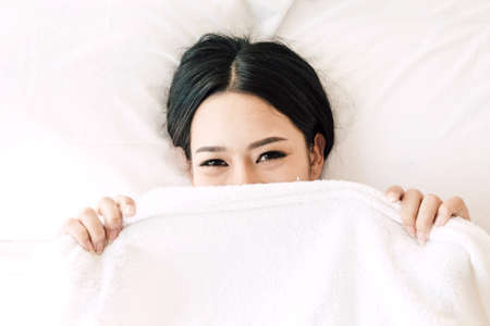 Pretty woman in bed under the blanket