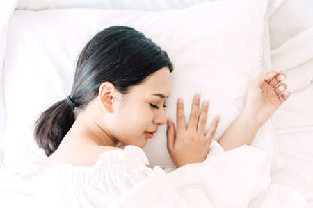 Top view of beautiful girl sleeps in the bedroom