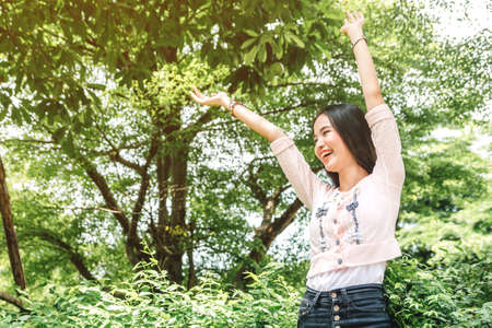 Woman standing stretch her arms relax and enjoy with nature fresh air