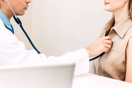 Doctor examining female patient with stethoscope in the hospital.healthcare and medicine