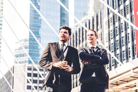 Image two business partners talking and working together while discussing new strategy at cityの写真素材