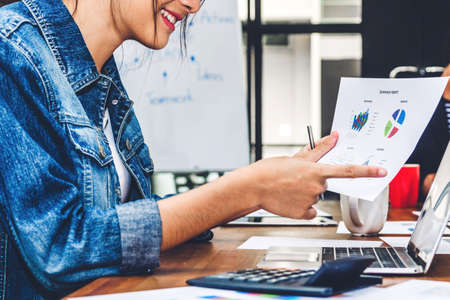 Young casual  businesswoman working and using laptop computer.creative woman planning with  report...