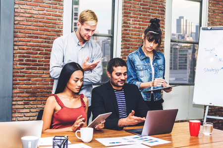 Group of casual business working and discussing strategy with desktop computer.creative business people planning and brainstorm in modern work loft.Teamwork conceptの写真素材