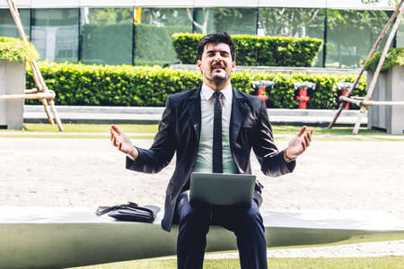 Handsome businessman in black elegant suit sitting and working with laptop computer.Man relax and...