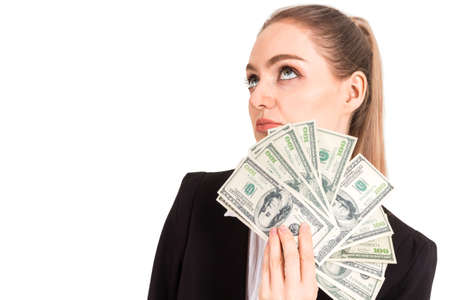 Beautiful and successful happy businesswoman in black suit holding money dollar notes isolated on...