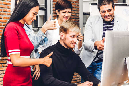 Group of casual business working and discussing strategy with desktop computer.creative business...